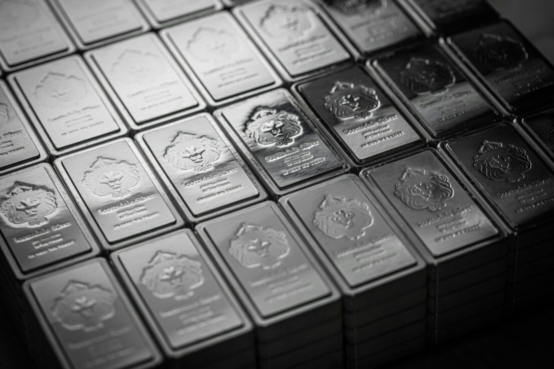 A pile of silver bars sitting on top of a table